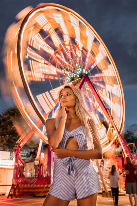 A Woman Rides A Carnival Ferris Wheel